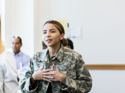 The mid adult female soldier meets with an unrecognizable female counselor at the family services center on the army post.