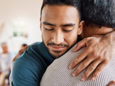 Shot of a father and son hugging at home