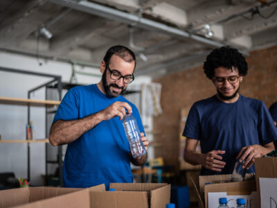 Volunteers arranging donations in a community charity donation center