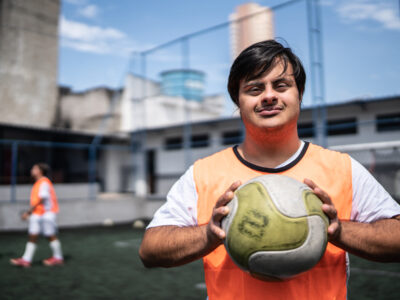 Portrait of a young male soccer player with special needs in a sports court