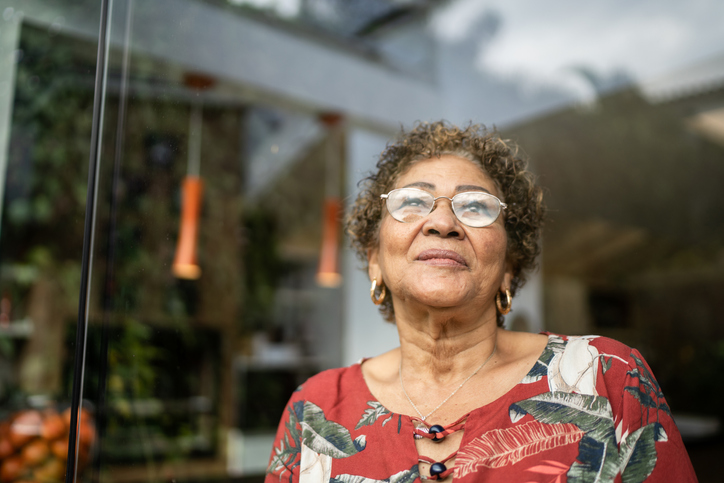 Happy senior woman contemplating at home