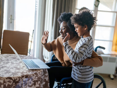 mother and her son using notebbok and having fun during a video call