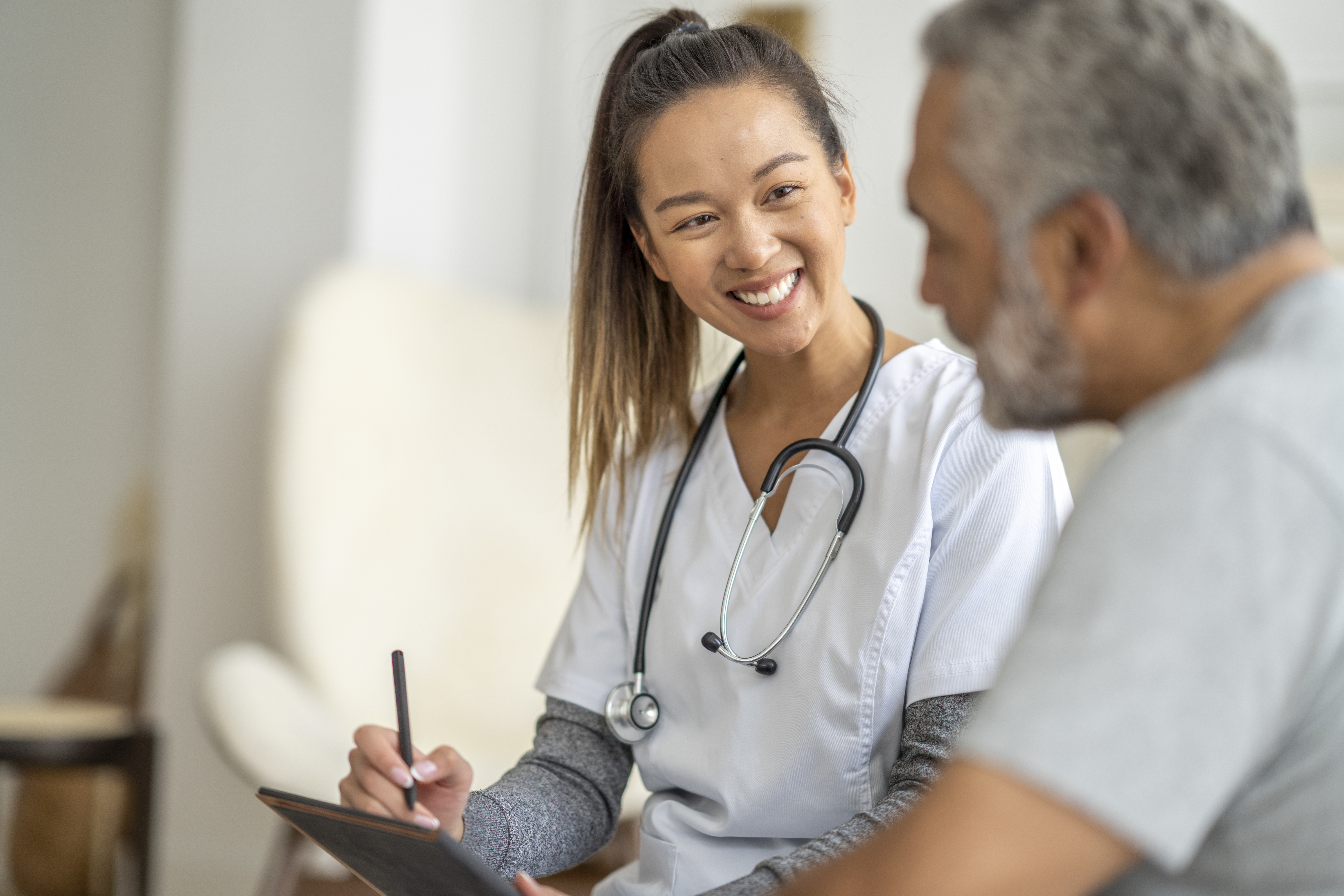 Skilled nurse speaking to patient