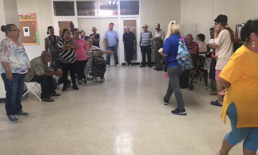 people waiting for supplies in puerto rico