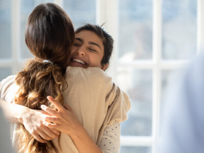 Girls friends hugging happy