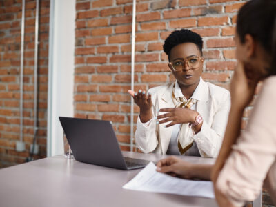 African American businesswoman communicating with female job candidate during a meeting in the office.