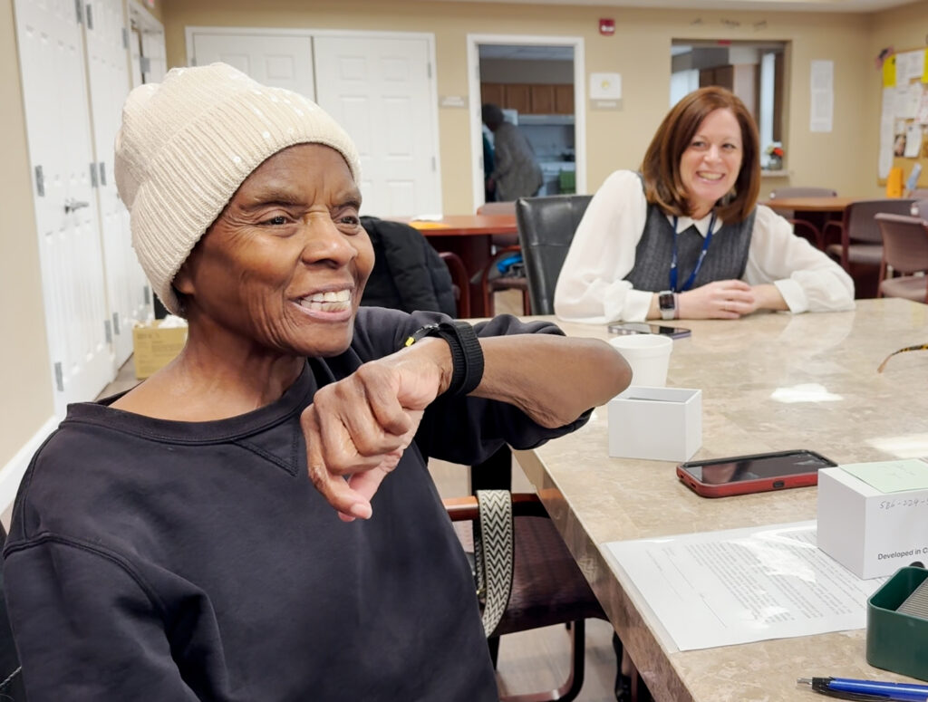 older woman talks into smart watch