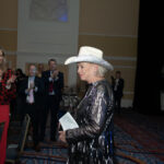 sharon magness blake smiles as she holds her award