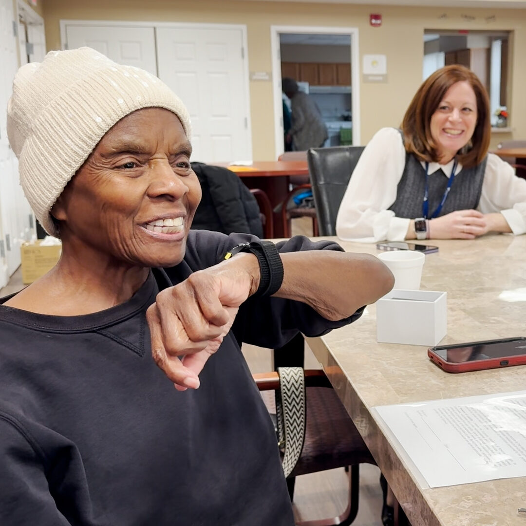 older woman talks into smart watch